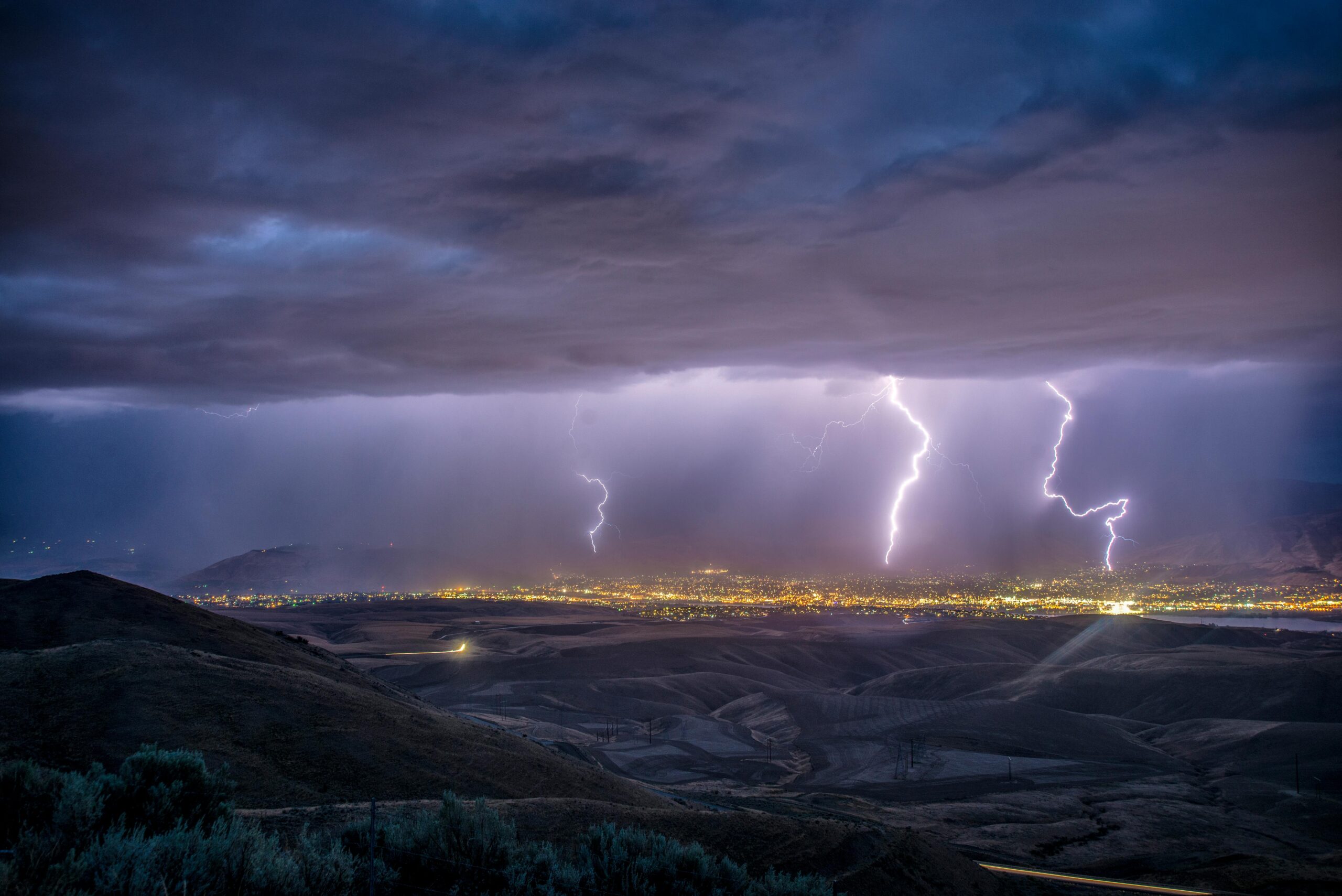 Dramatic lightning storm over Washington's countryside at dusk.